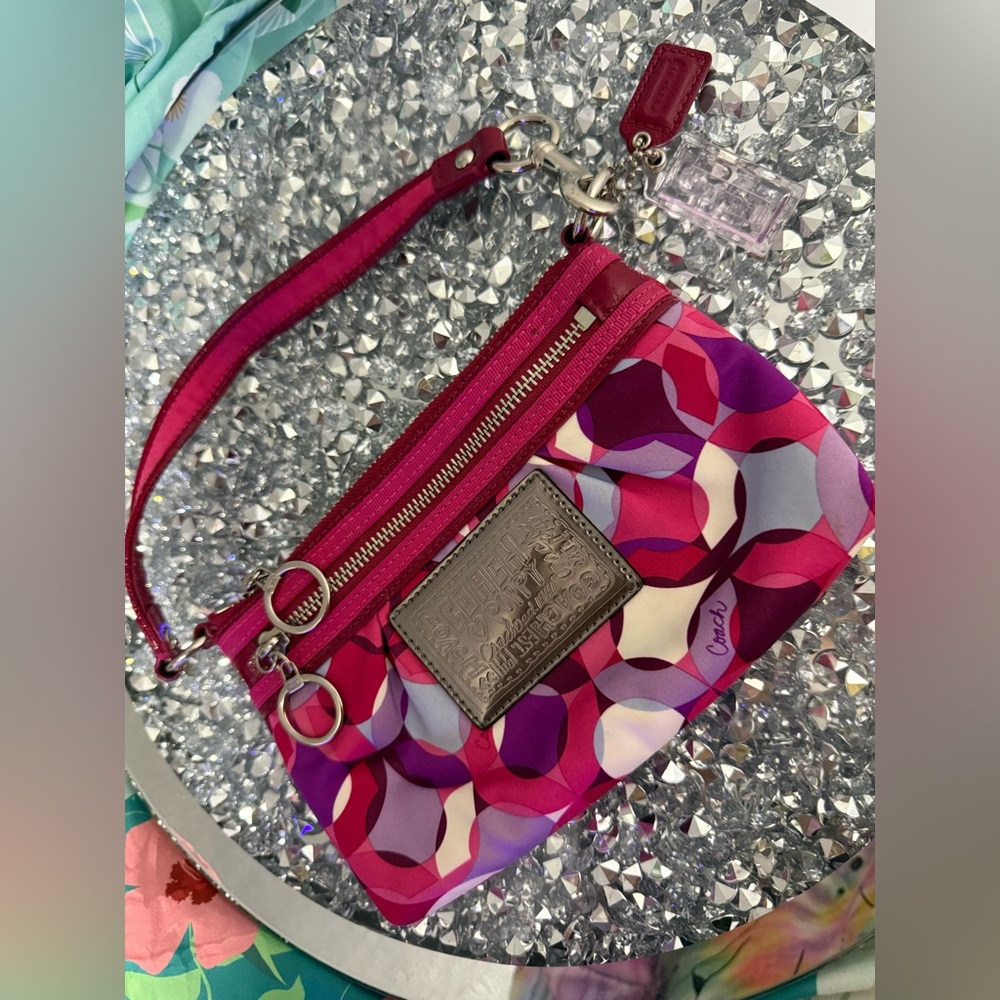 Coach Poppy Wristlet featuring a pink and purple geometric pattern. - Picture 9 of 9